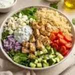 Delicious Greek Chicken bowls with fresh vegetables and flavorful toppings